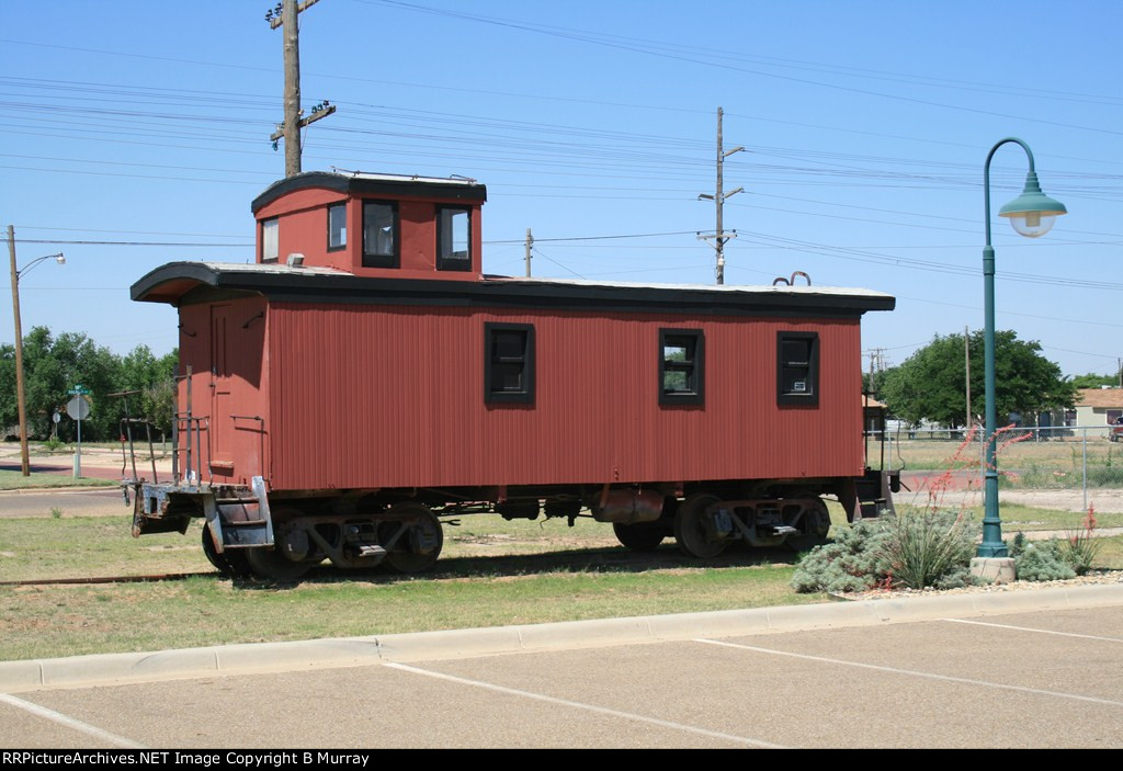Unmarked wooden caboose on ATSF line.
